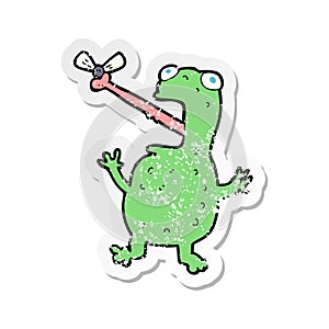 retro distressed sticker of a cartoon frog catching fly