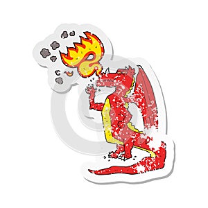 retro distressed sticker of a cartoon happy dragon breathing fire