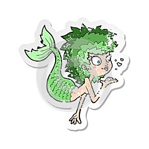 retro distressed sticker of a cartoon mermaid blowing a kiss