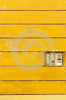 Retro doorbell: electric intercom on te yellow wall texture