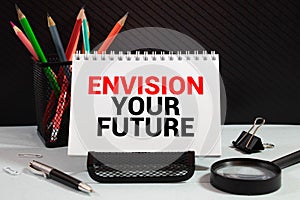 Retro effect and toned image of a fountain pen on a notebook. Handwritten text Envision Your Future