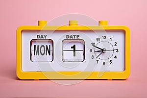 Retro electronic alarm clock and analog flip calendar. Retro design from 60s 70s home interior. Bright yellow color