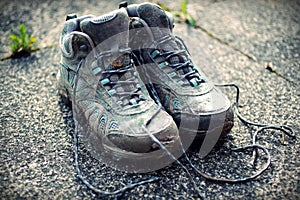 Retro Faded Photo Of Dirty Walking Boots on Sidewalk