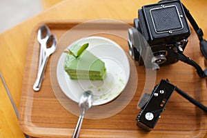 Retro film camera and green tea cake