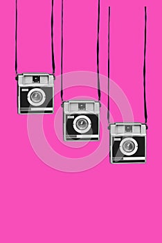 Retro film cameras on a pink background