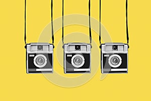 retro film cameras on a yellow background