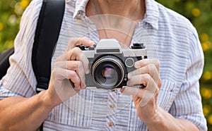 Retro film photo camera in female hands