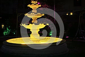 retro fountain illuminated at night