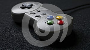 Retro Game Controller on Black Surface