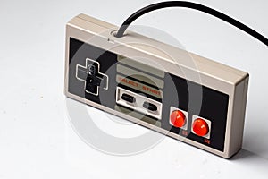 Retro gaming controller with cable on white background