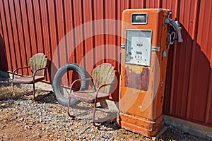 Retro gas pump and rusted chairs