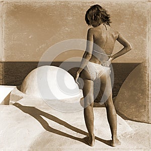 Retro girl stands on the beach