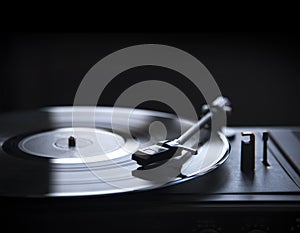 Retro gramophone vinyl player over black background with copyspace.