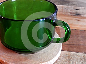 Retro Green Coffee Cup on Coaster Wood Table