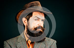 Retro handsome man, portrait face of serious bearded hipster on black background.