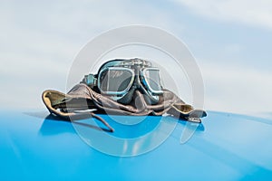 Retro hat and goggles on blue wings