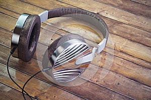 Retro headphones on table. Vintage old style 3d render illustration