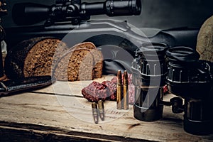 Retro hunting ammunition of rifle and binoculars.