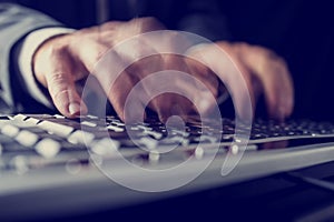 Retro image of a businessman typing on a computer keyboard