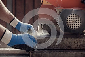 Retro image of workman using an angle grinder or circular saw to