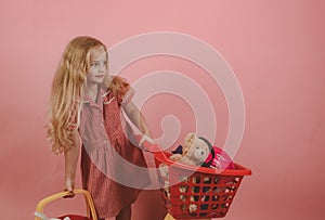 Retro inspired. Little shopaholic with shopping cart. Little girl shopping. Small girl in shop. Small shopper. I love
