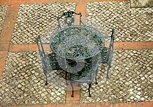 Retro iron garden furniture set on paved patio