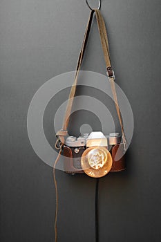 Retro lamp from an old camera with an Edison lamp on a gray background. Concept is a good idea