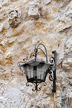 Retro lantern on old stone wall background, Antibes, France photo