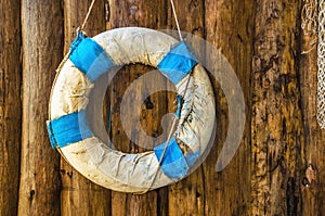 Retro lifebuoy in Greek national colors blue and white hanging o