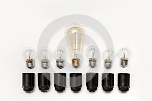 Retro light bulb and electric black cartridges to them on a white background isolated. View from above