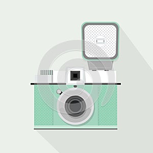 Retro light teal camera with flash and long shadow