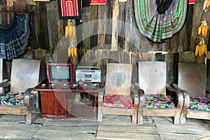 Retro living room interior with old TV, tape recorder, chairs, armchairs and a table. Walls of boards, plank floor. Nostalgia. Nor