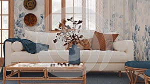 Retro living room in white and blue tones closeup. Sofa, rattan table with autumn decors. Boho chic design, fall interior concept