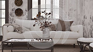 Retro living room in white and dark tones closeup. Sofa, rattan table with autumn decors. Boho chic design, fall interior concept