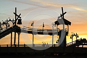 Retro log flume ride set against orange sunset sky