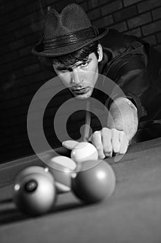 Retro male shooting pool.