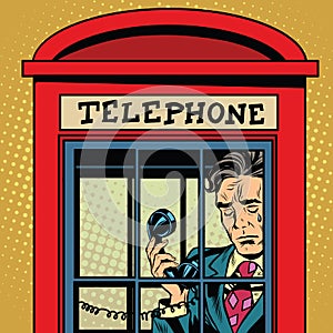 Retro man crying in a phone booth