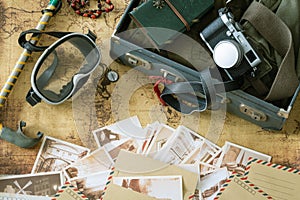 Retro mask and snorkel with a suitcase, notebook, old map and postcards and travel equipment