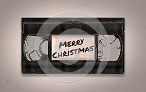 A retro MERRY CHRISTMAS old and distressed black VHS video tape illustration background with copy space
