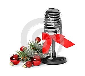 Retro microphone with red bow and festive decor on white background. Christmas music