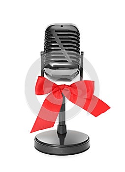 Retro microphone with red bow isolated on white. Christmas music