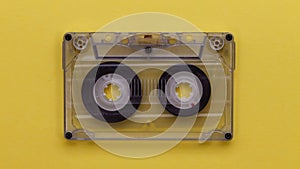 Retro music compact cassette reeling tape as if playing