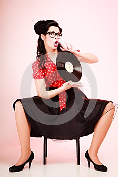 Retro music. Pinup girl with vinyl record