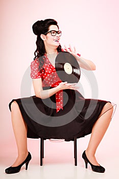 Retro music. Pinup girl with vinyl record