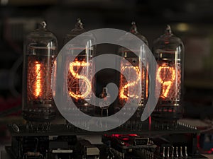 Retro Nixie lamp indicator clock on dark background