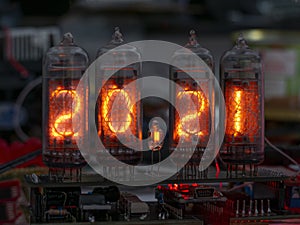 Retro Nixie lamp indicator clock on dark background 2021 number