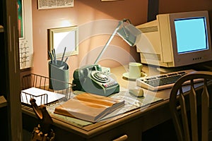 Retro office desk in dark room with simulator object.