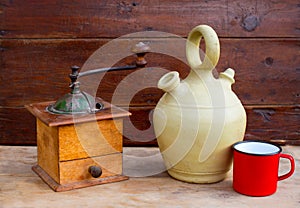 Retro old coffee grinder and botijo in vintage wood photo