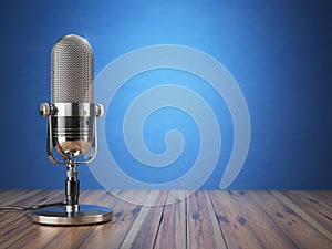 Retro old microphone. Radio show or audio podcast concept. Vintage microphone on blue background. photo