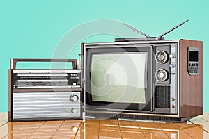 Retro old TV set and FM radio receiver. Broadcasting concept on the wooden desk. 3D rendering